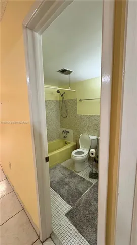 a bathroom with a granite countertop bathtub shower