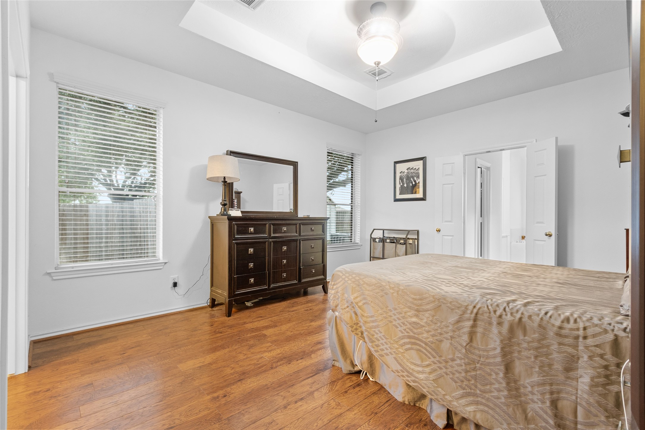 21014 Jessica Rose Lane Spring, TX 77379 - Photo 19 of 30 a spacious bedroom with a bed and a dresser
