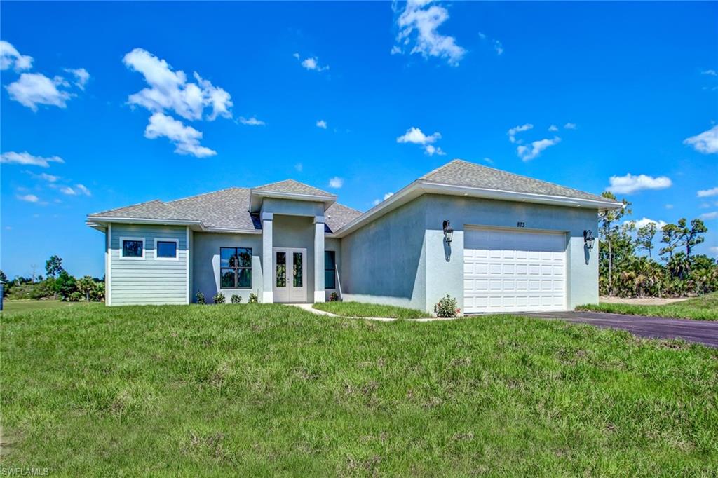 873 18th Street Northeast Naples, FL 34120 - Photo 1 of 25 a view of a house with a yard