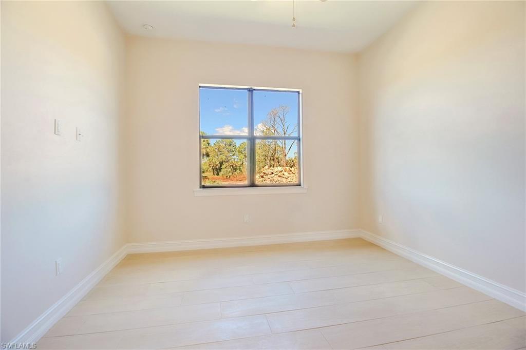 873 18th Street Northeast Naples, FL 34120 - Photo 16 of 25 an empty room with a window