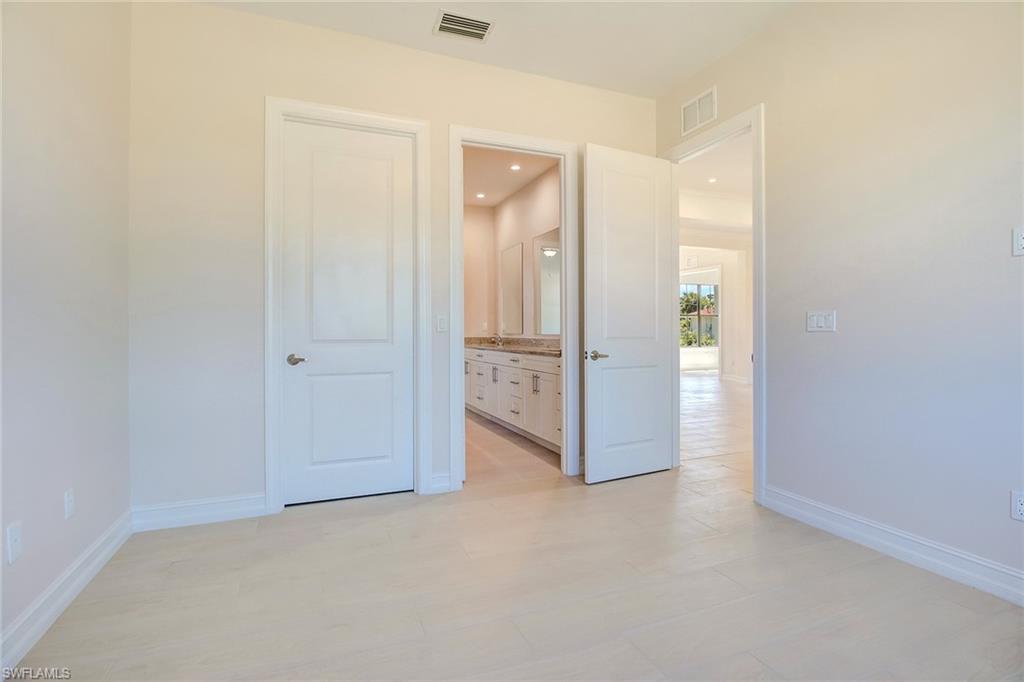 873 18th Street Northeast Naples, FL 34120 - Photo 17 of 25 an empty room with a bathroom and a sink