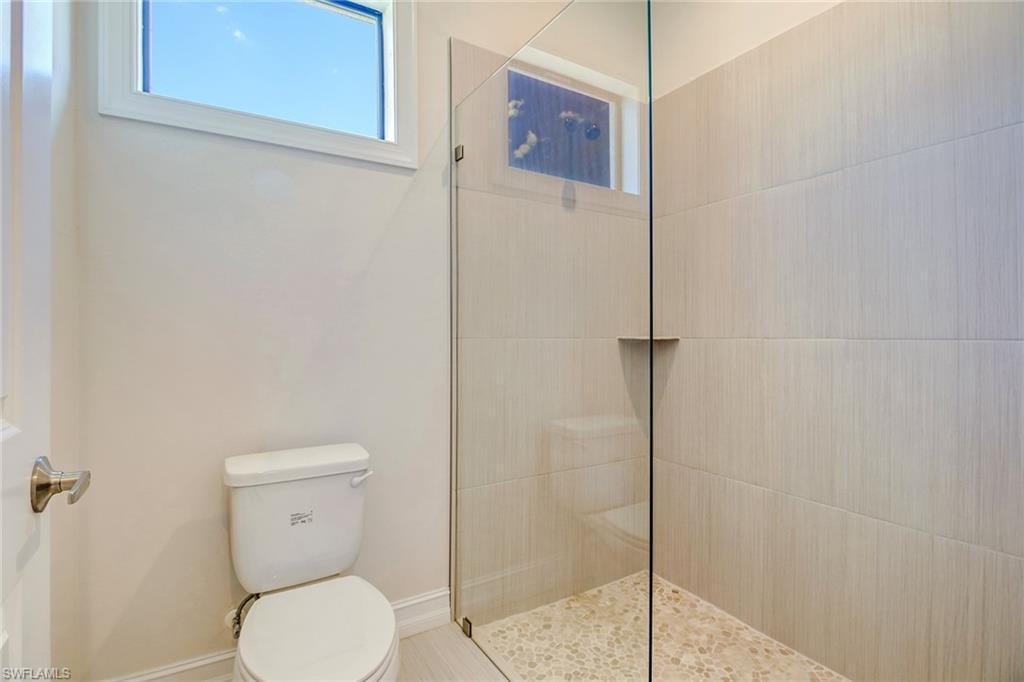 873 18th Street Northeast Naples, FL 34120 - Photo 19 of 25 a bathroom with a toilet and a shower
