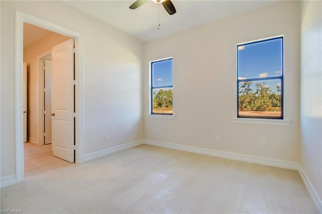 873 18th Street Northeast Naples, FL 34120 - Photo 20 of 25 an empty room with windows and closet