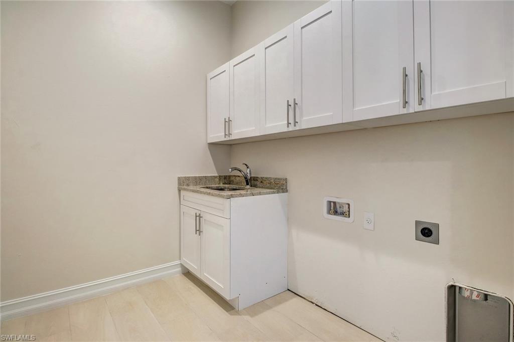 873 18th Street Northeast Naples, FL 34120 - Photo 21 of 25 a room with cabinets