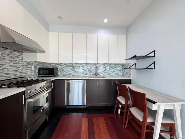 a kitchen with a stove and white cabinets