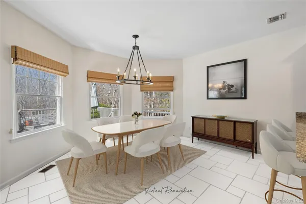 a large white kitchen with cabinets