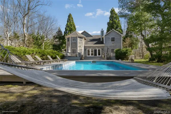 a view of a white house with a yard