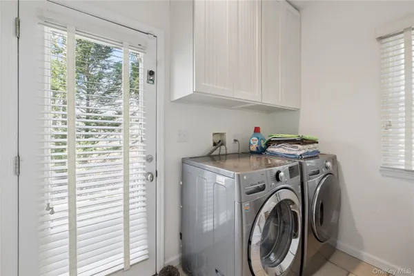 a bathroom with a toilet sink vanity and mirror