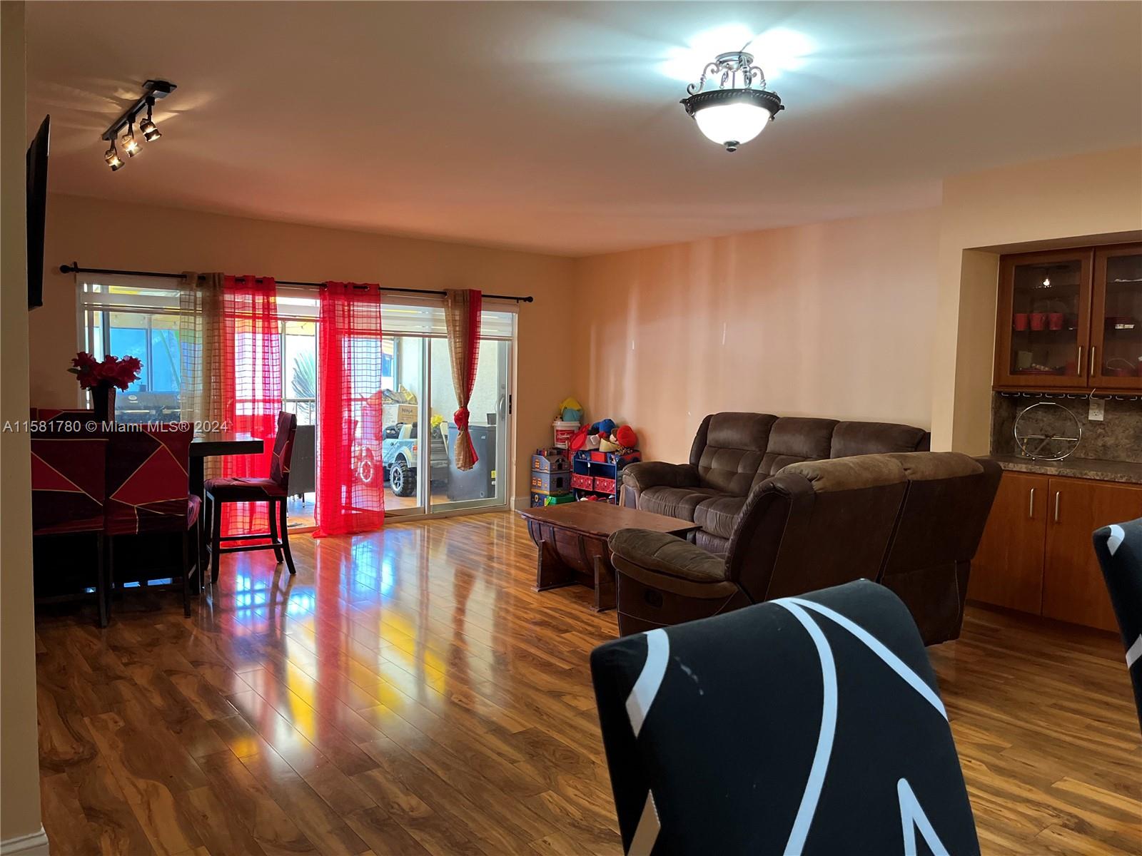 16500 Bridge End Road Miami Lakes, FL 33014 - Photo 7 of 17 a living room with furniture and a large window