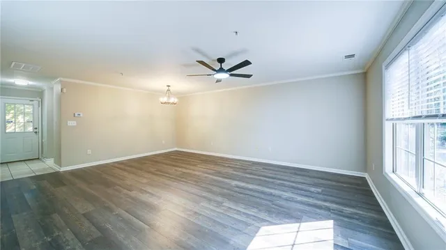 wooden floor in an empty room with a window
