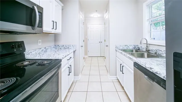 a kitchen with stainless steel appliances granite countertop a stove and a sink