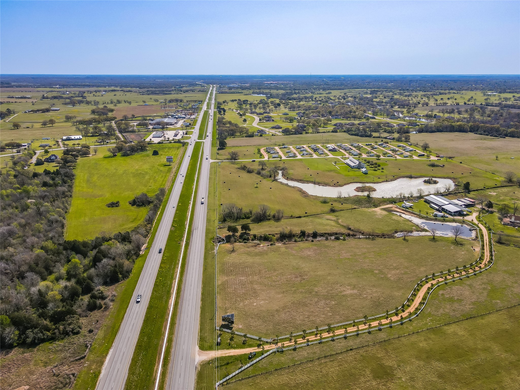 52825 Highway 290 Hempstead, TX 77445 - Photo 6 of 6 an aerial view of residential houses with outdoor space