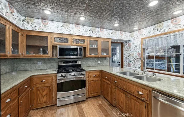 a kitchen with stainless steel appliances granite countertop a stove and a sink