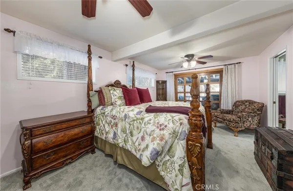 a bedroom with bed and windows