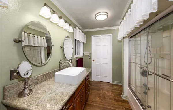 a bathroom with a granite countertop sink mirror and vanity
