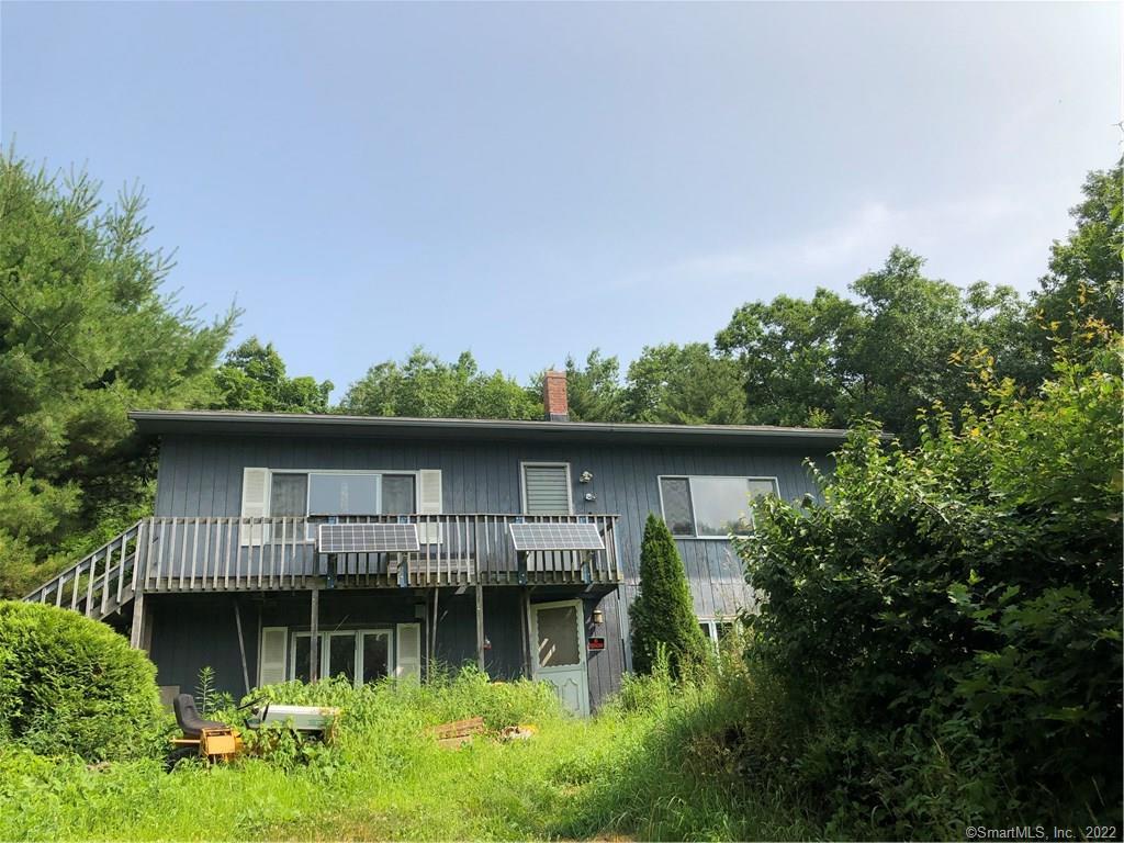 a front view of house with a garden