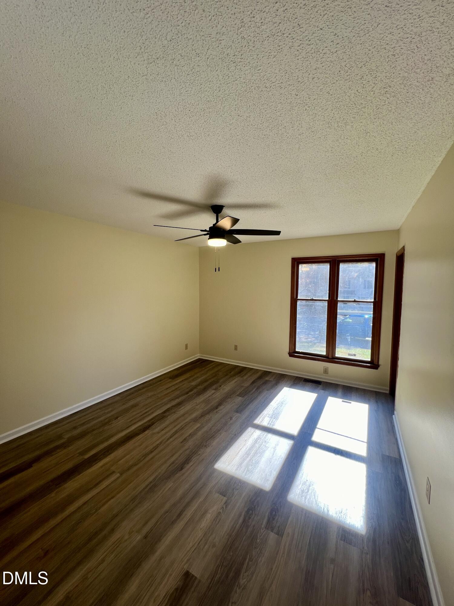 5132 Vann Street, Unit B Raleigh, NC 27606 - Photo 8 of 9 an empty room with wooden floor and windows