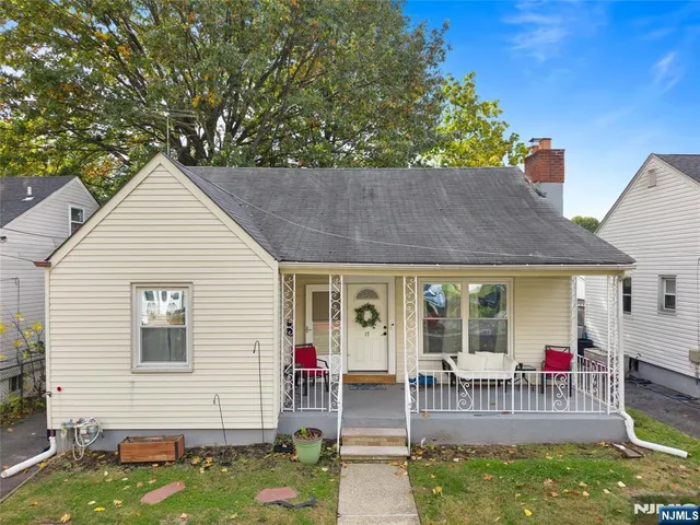 a front view of a house with a garden and porch