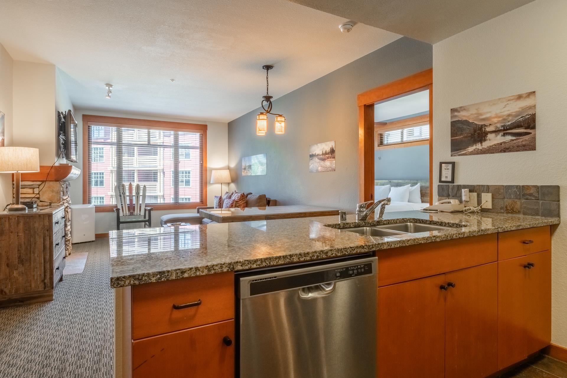 6201 Minaret Road, Unit 2312 Mammoth Lakes, CA 93546 - Photo 13 of 41 a kitchen with stainless steel appliances granite countertop a sink a stove and a wooden cabinets