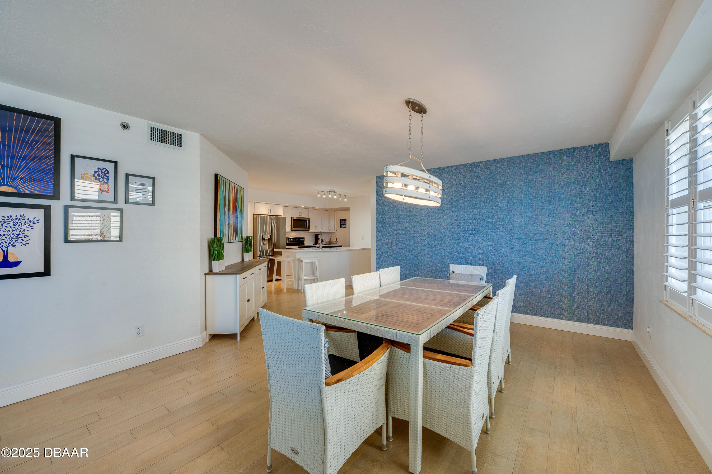4545 South Atlantic Avenue, Unit 3206 Ponce Inlet, FL 32127 - Photo 11 of 35 a view of a dining room with furniture window and wooden floor