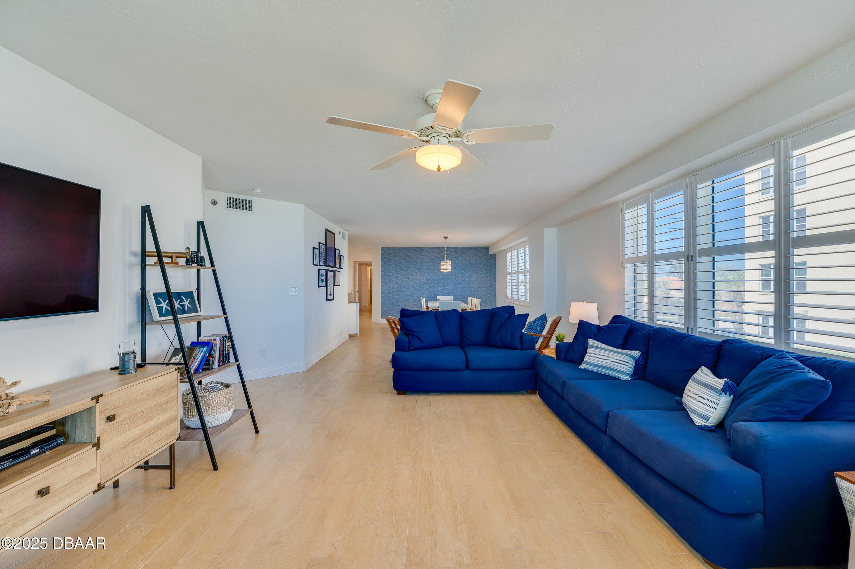 4545 South Atlantic Avenue, Unit 3206 Ponce Inlet, FL 32127 - Photo 16 of 35 a living room with furniture and a flat screen tv