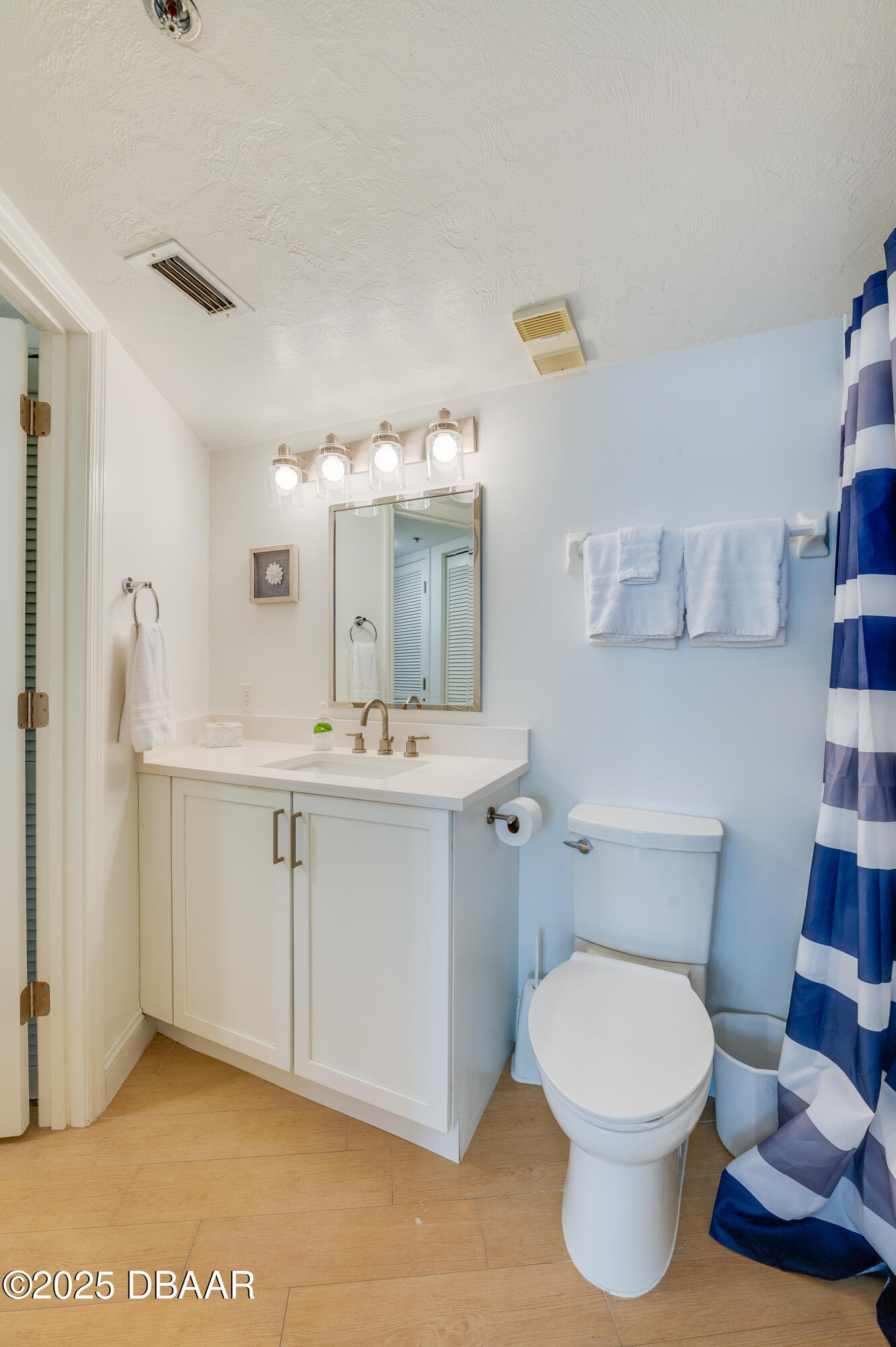 4545 South Atlantic Avenue, Unit 3206 Ponce Inlet, FL 32127 - Photo 26 of 35 a bathroom with a sink a toilet and mirror