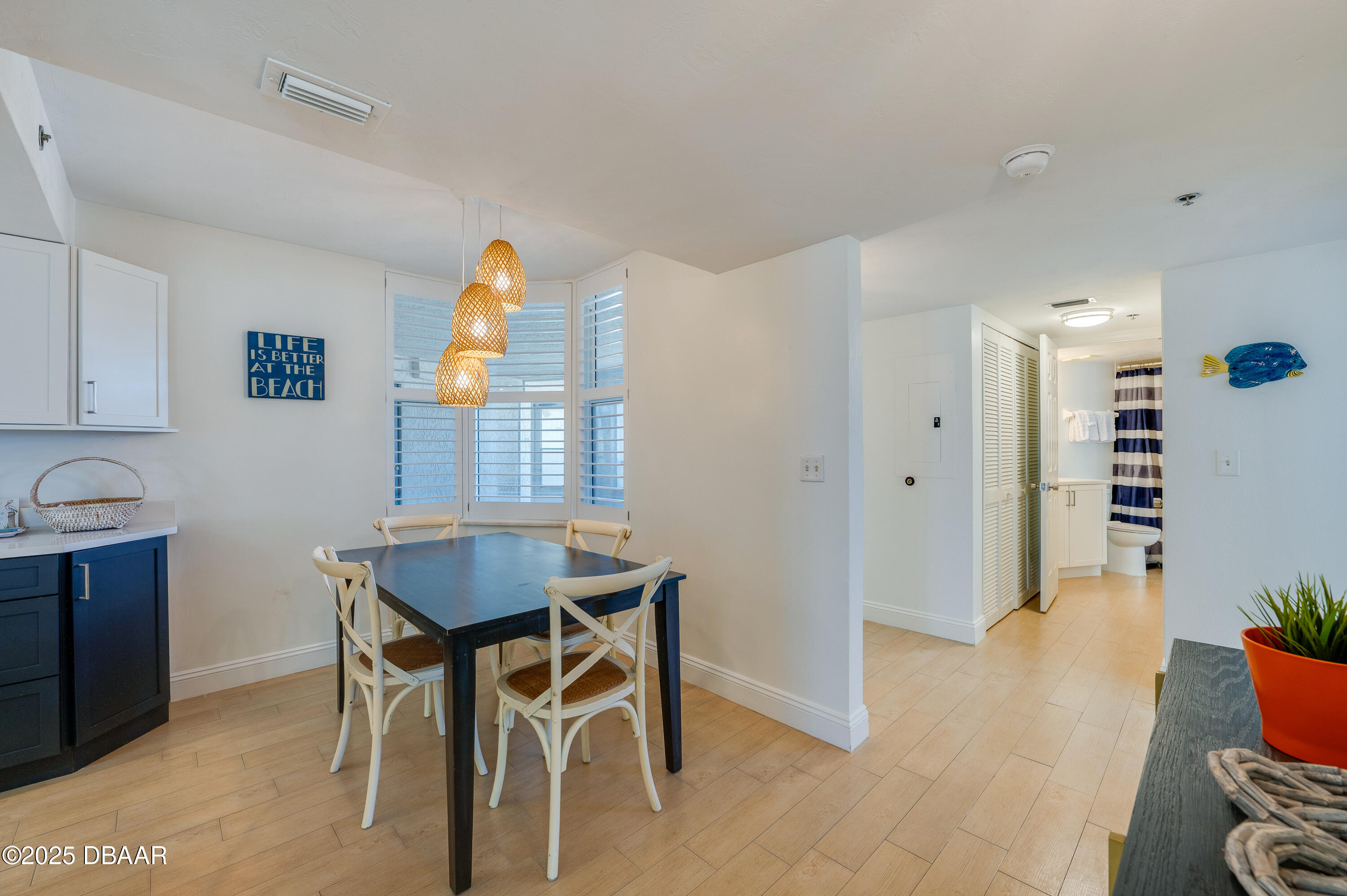 4545 South Atlantic Avenue, Unit 3206 Ponce Inlet, FL 32127 - Photo 5 of 35 a view of a dining room with furniture and wooden floor