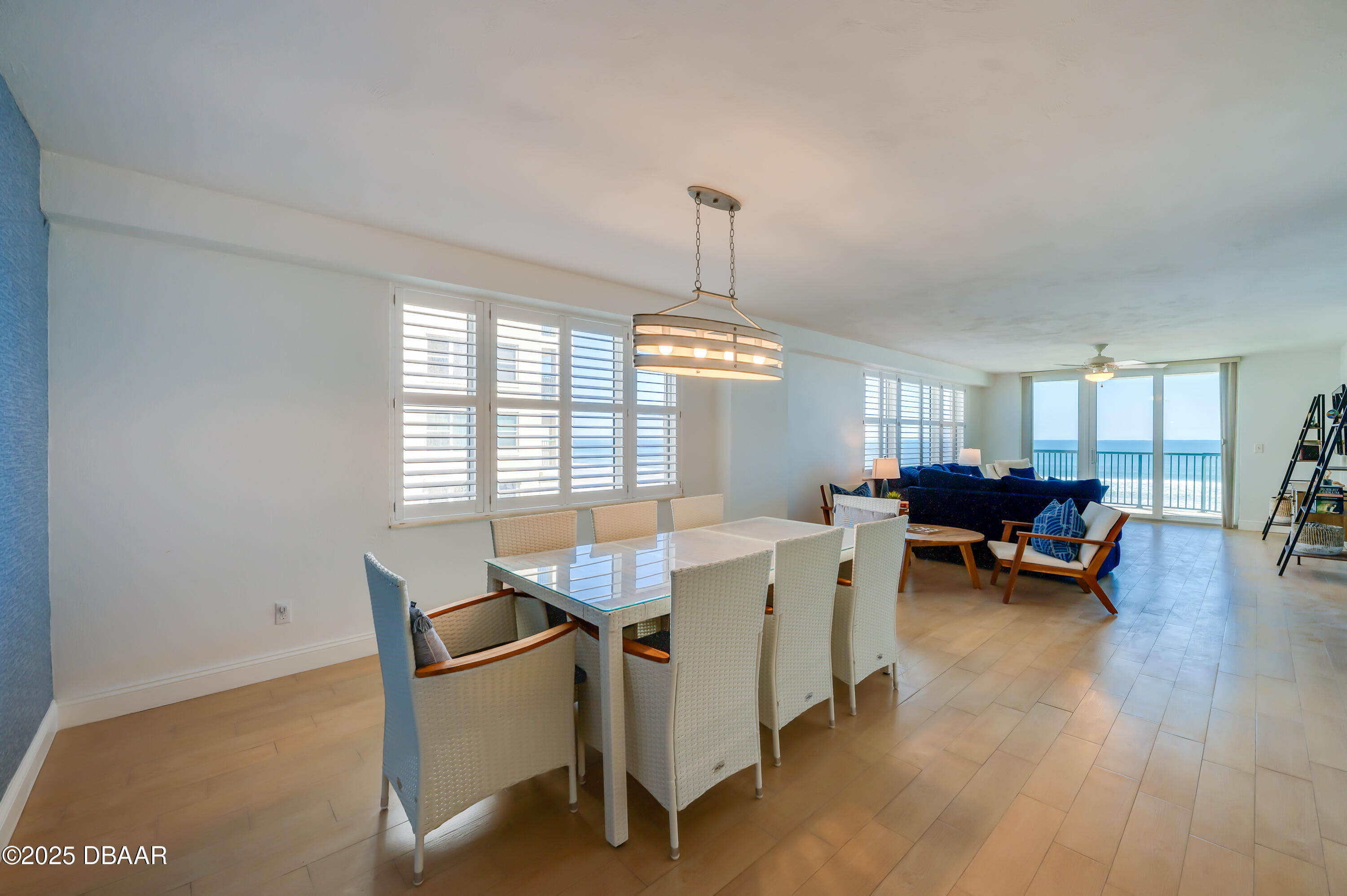 4545 South Atlantic Avenue, Unit 3206 Ponce Inlet, FL 32127 - Photo 9 of 35 a view of a dining room with furniture window and wooden floor