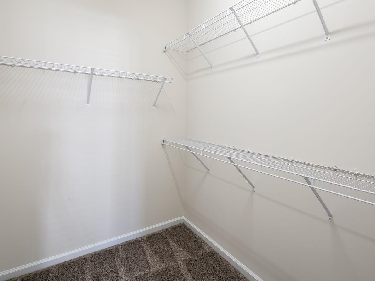 9133 Wooden Road Raleigh, NC 27617 - Photo 18 of 26 As you can see the townhouse is now vacant. The bed, tables, lamps and other items are "staging" so you can better imagine how your personal property would look inside 9133 Wooden Road. Another view of the closet
