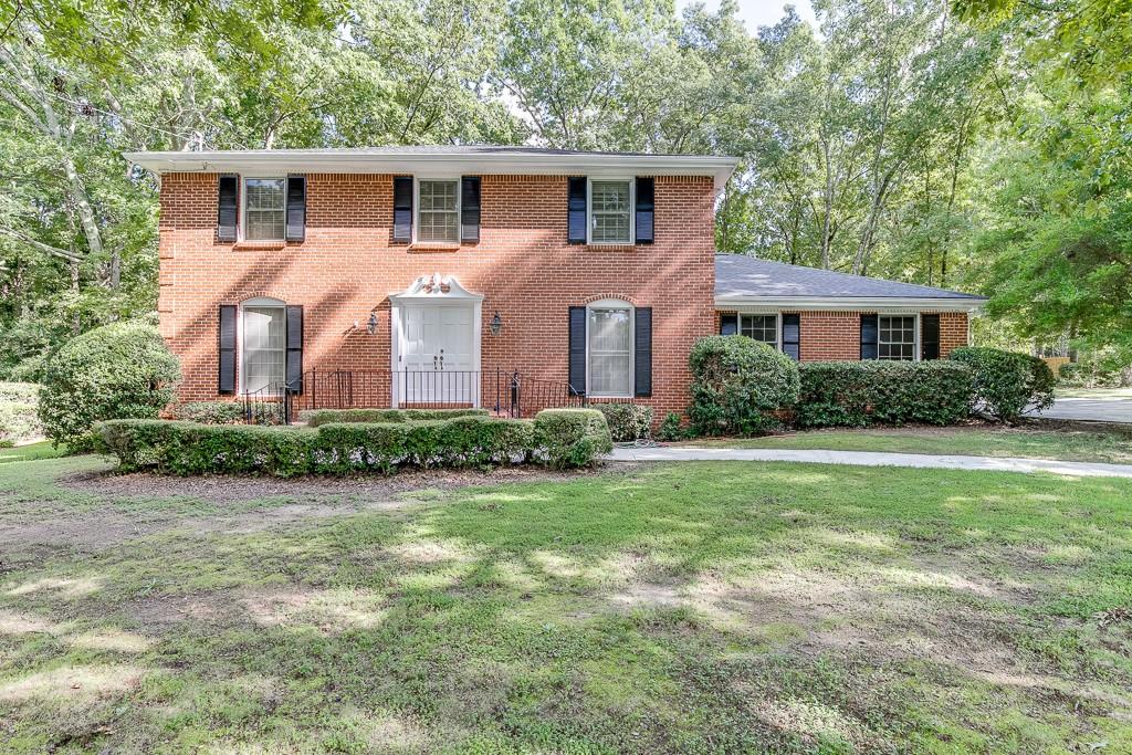 462 Summit Ridge Drive Lawrenceville, GA 30046 - Photo 1 of 1 a front view of a house with a garden