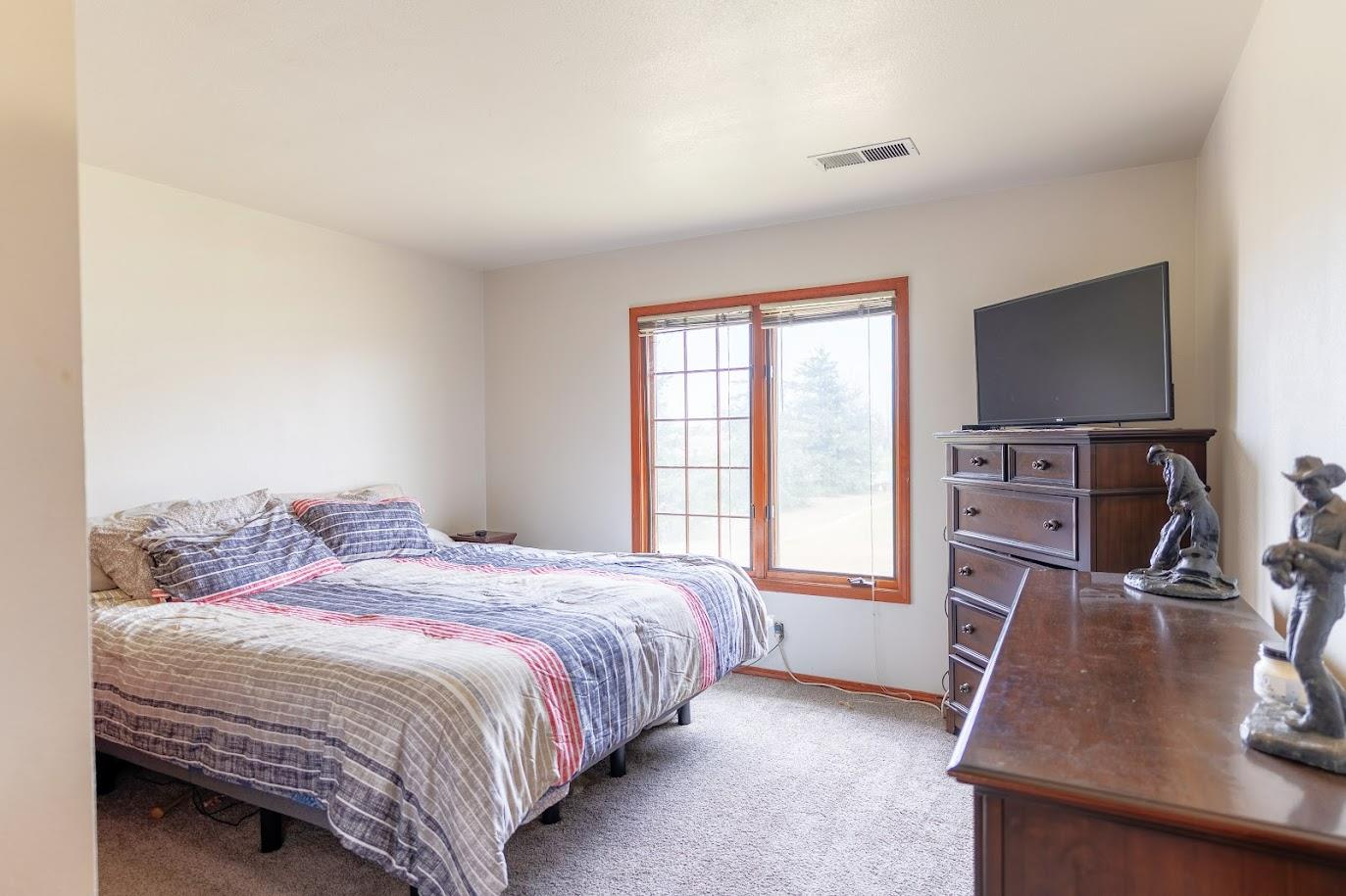 11175 East South Avenue Del Rey, CA 93616 - Photo 17 of 31 a bedroom with a bed and a flat screen tv