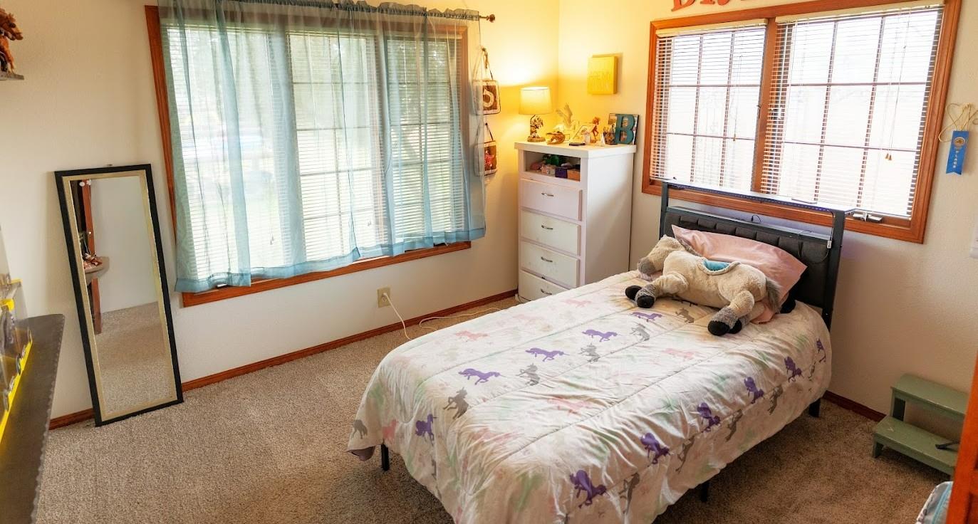 11175 East South Avenue Del Rey, CA 93616 - Photo 19 of 31 a bed sitting in a bedroom next to a window