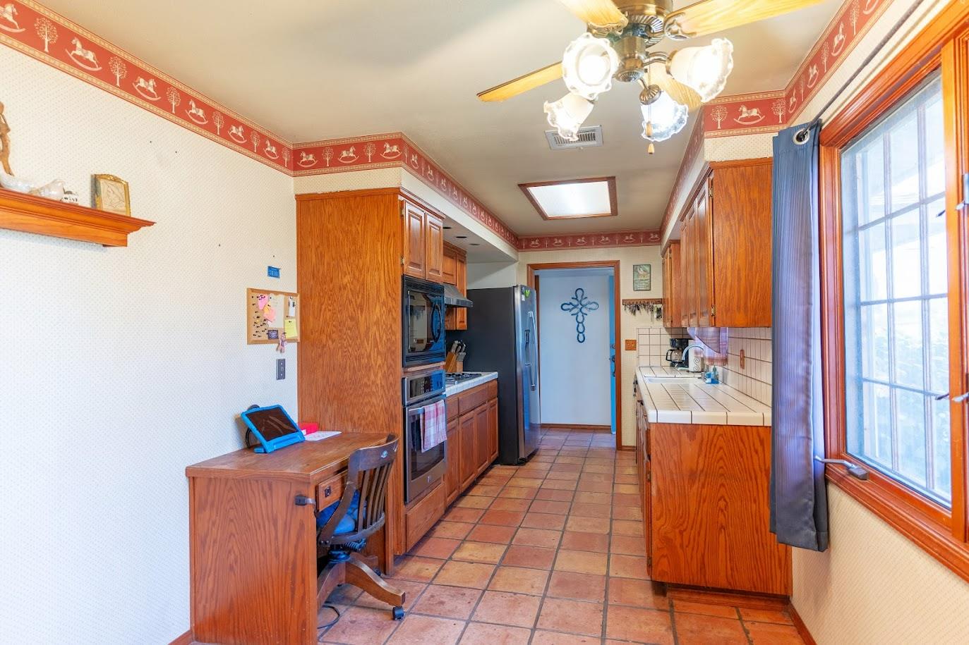 11175 East South Avenue Del Rey, CA 93616 - Photo 8 of 31 a hallway with painting on the wall and a large window