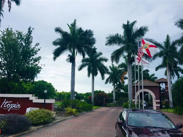a lake view with a big yard and large trees