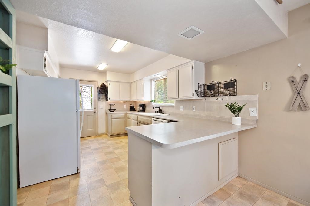 41107 Skyline Drive Emigrant Gap, CA 95715 - Photo 6 of 21 a kitchen with kitchen island a sink appliances and cabinets