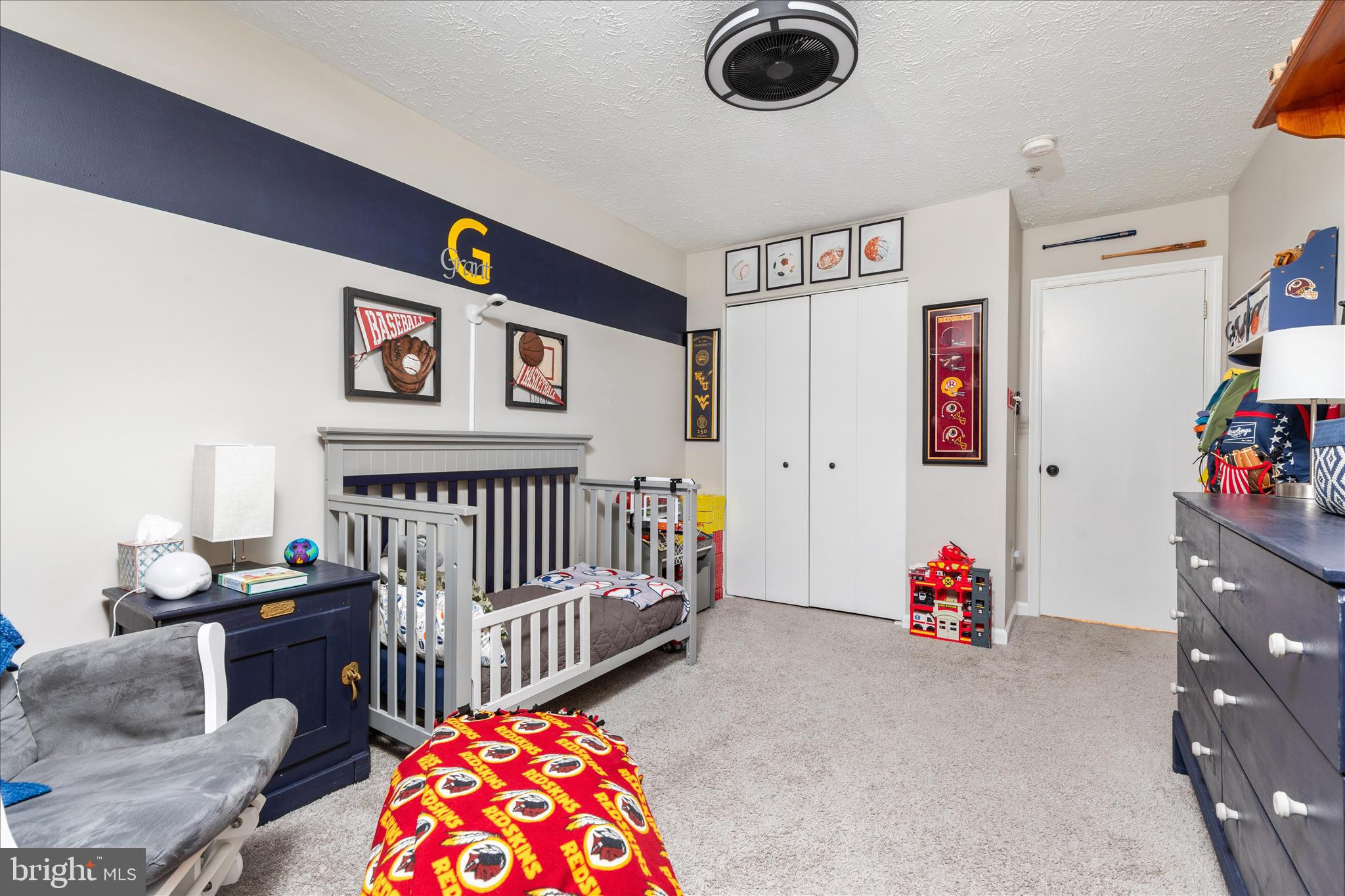 157 Brookland Terrace, Unit 11 Winchester, VA 22602 - Photo 14 of 22 a bedroom with furniture and a chandelier
