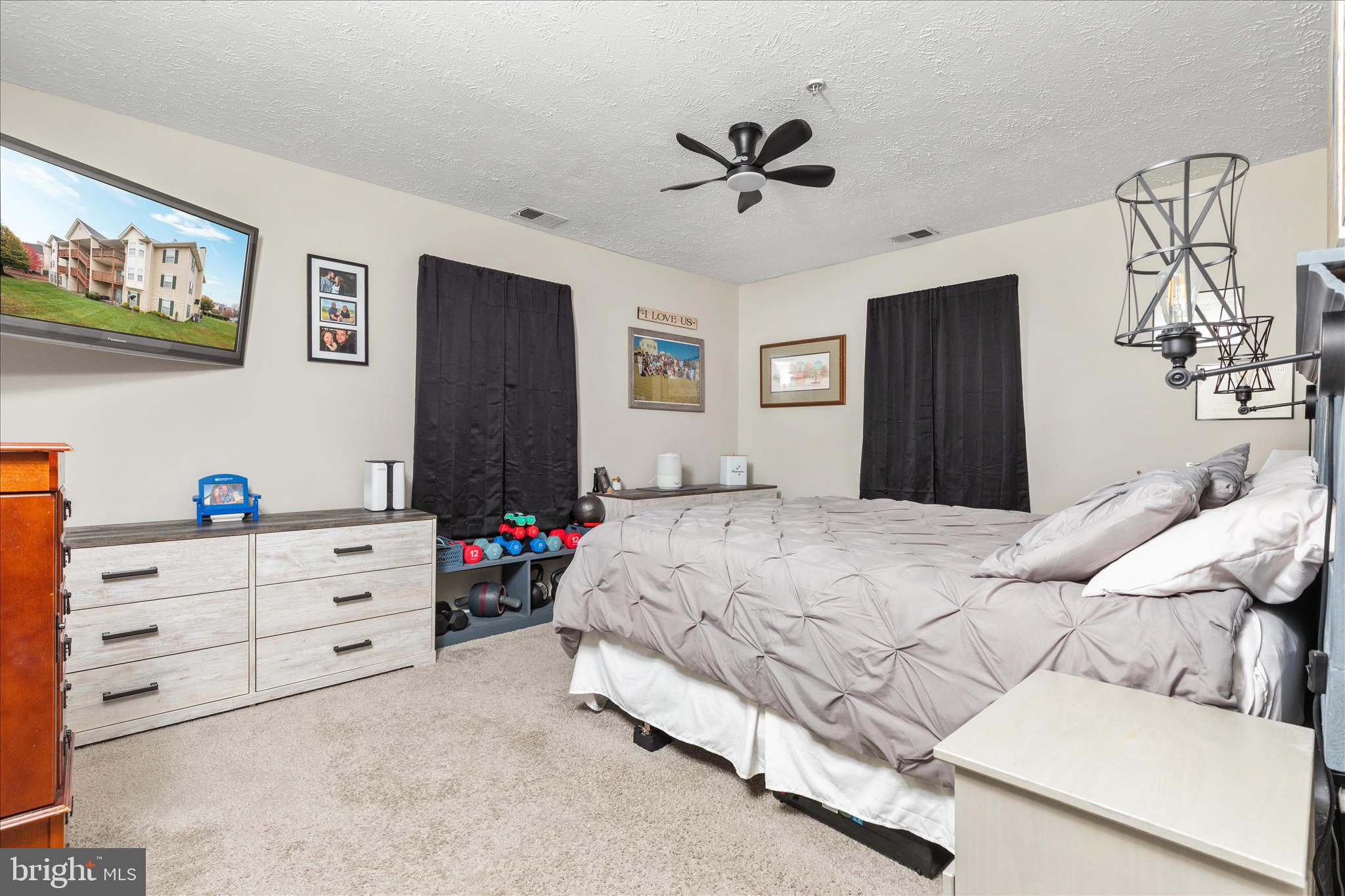 157 Brookland Terrace, Unit 11 Winchester, VA 22602 - Photo 16 of 22 a bedroom with a bed and a chandelier