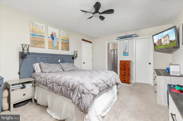 a spacious bedroom with a bed and a window