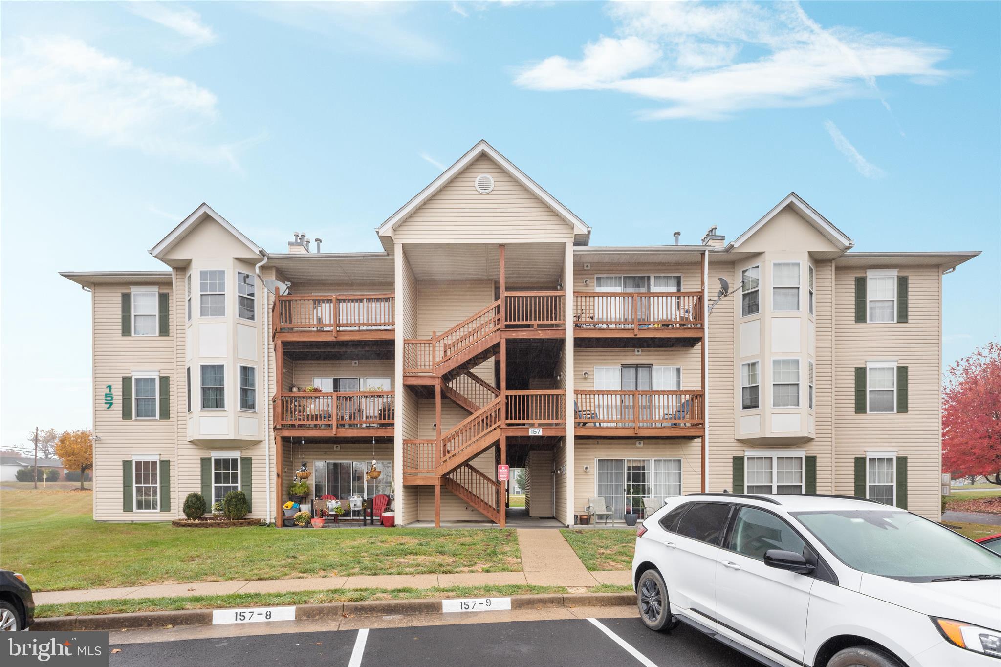 157 Brookland Terrace, Unit 11 Winchester, VA 22602 - Photo 21 of 22 a view of a car parked in front of a brick building