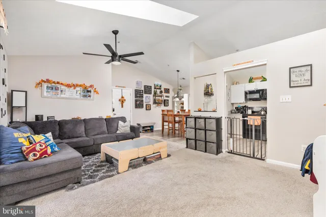 a living room with furniture and a ceiling fan