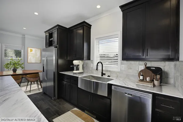 a kitchen with stainless steel appliances granite countertop a refrigerator and a sink