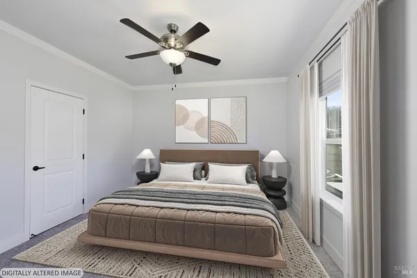 a bedroom with a large bed and a chandelier