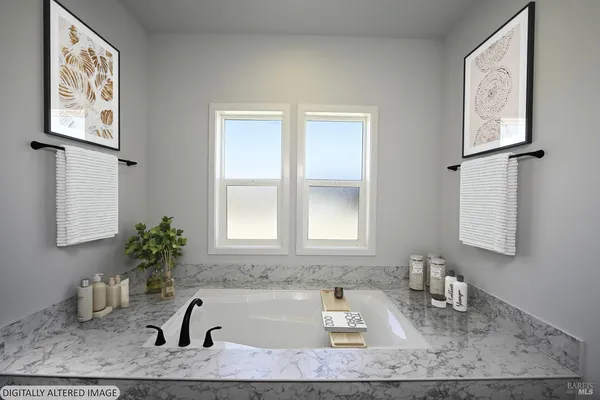 a bathroom with bathtub and window