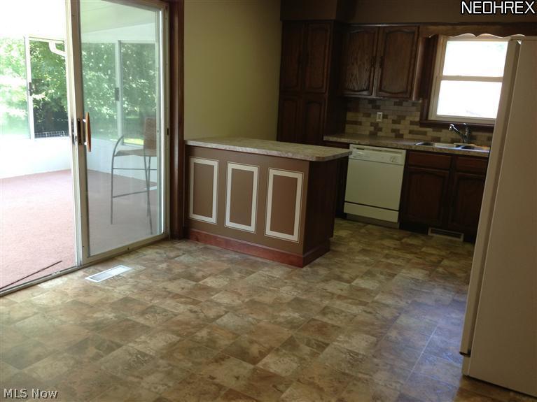 Sliders leading out to sunroom. Island for extra workspace.
