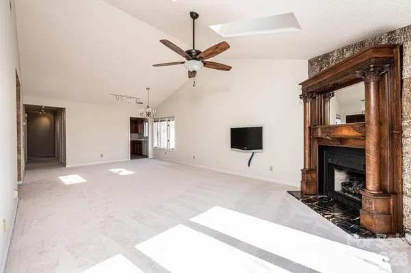 a view of empty room with fireplace and fan