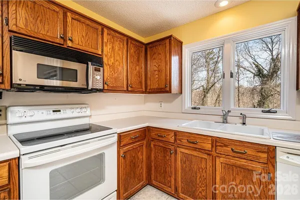 a kitchen with a stove microwave and sink