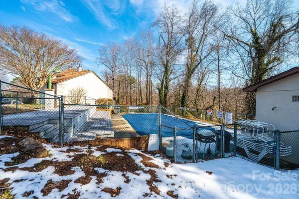 a view of residential houses with outdoor space and street view