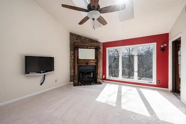 a view of livingroom with furniture a flat screen tv and a fireplace