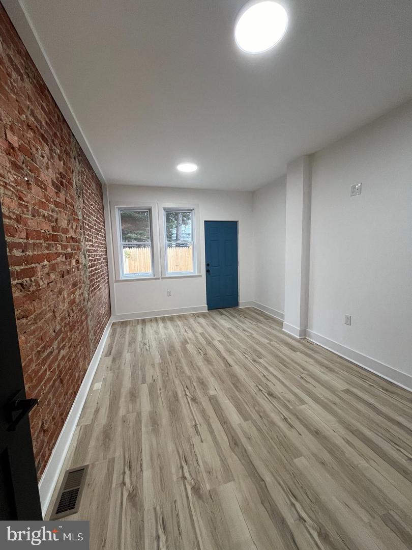 4817 North 15th Street Philadelphia, PA 19141 - Photo 6 of 10 wooden floor in an empty room with a window