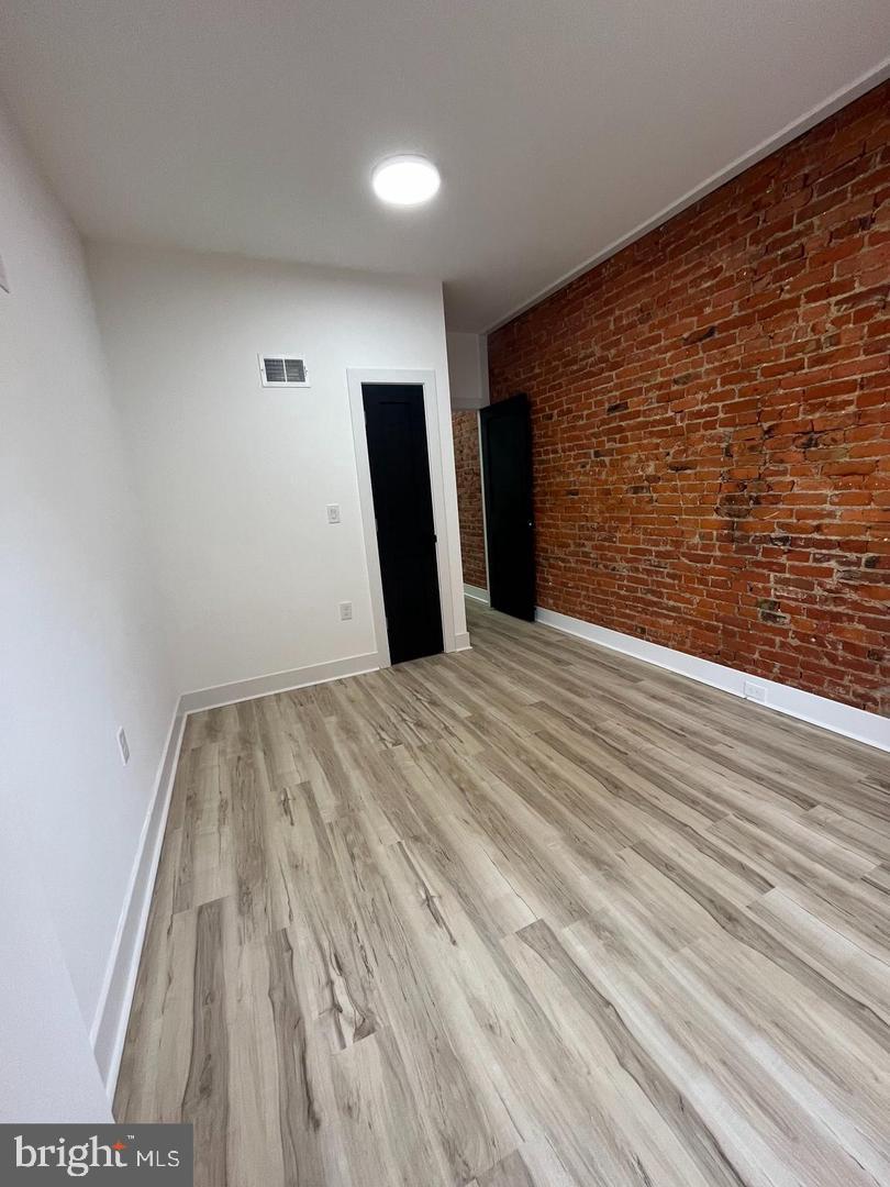 4817 North 15th Street Philadelphia, PA 19141 - Photo 7 of 10 a view of an empty room with wooden floor